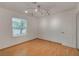 Bedroom with wood floors, natural light from the window, and a white door to the hallway at 4430 Eureka Cir, Las Vegas, NV 89103