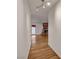 Bright hallway leading to a spacious living area with hardwood floors and a stone fireplace at 4430 Eureka Cir, Las Vegas, NV 89103