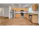 Updated kitchen with wood floors, light wood cabinets, granite countertops, and stainless steel appliances at 4430 Eureka Cir, Las Vegas, NV 89103
