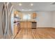 Updated kitchen boasting wood floors, light wood cabinets, granite countertops, and stainless steel appliances at 4430 Eureka Cir, Las Vegas, NV 89103