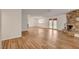 Open living space with hardwood floors, a stone fireplace, and double doors to the backyard at 4430 Eureka Cir, Las Vegas, NV 89103