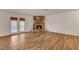 Spacious living room featuring hardwood floors, a stone fireplace, and access to the backyard at 4430 Eureka Cir, Las Vegas, NV 89103