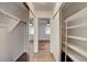 Walk-in closet with mirrored doors and custom shelves and cabinets for optimal storage at 4430 Eureka Cir, Las Vegas, NV 89103