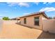 Backyard features gravel, partial block wall, and house with a tile roof at 4436 Hatch Bend Ave, North Las Vegas, NV 89031