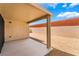 Covered patio and gravel-filled backyard with a block wall and partial view of neighbors at 4436 Hatch Bend Ave, North Las Vegas, NV 89031