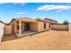 Gravel backyard features a covered patio area with sliding door entrance into the house at 4436 Hatch Bend Ave, North Las Vegas, NV 89031