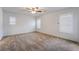 Spacious bedroom with neutral carpet and ample natural light from multiple windows with shutters at 4436 Hatch Bend Ave, North Las Vegas, NV 89031