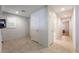 Neutral hallway featuring tile flooring, storage closets, and doors that lead to other rooms at 4436 Hatch Bend Ave, North Las Vegas, NV 89031
