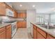 Well-lit kitchen featuring granite countertops, stainless steel appliances and light wood cabinetry at 4436 Hatch Bend Ave, North Las Vegas, NV 89031