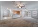 Open concept living room with ceiling fans, and an open view into the kitchen, creating a spacious living space at 4436 Hatch Bend Ave, North Las Vegas, NV 89031