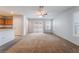 Open concept living room featuring a ceiling fan, light-colored walls, plush carpet, and a sliding glass door at 4436 Hatch Bend Ave, North Las Vegas, NV 89031