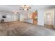 Spacious living room open to the kitchen with modern ceiling fans and light-colored walls at 4436 Hatch Bend Ave, North Las Vegas, NV 89031