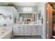 A beautifully designed bathroom featuring dual sinks and tub at 4515 Sandstone Vista Ct, North Las Vegas, NV 89031