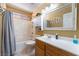 This bathroom features a bathtub/shower combination and a mirrored vanity at 4515 Sandstone Vista Ct, North Las Vegas, NV 89031