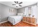 A cozy bedroom featuring wood floors and natural light at 4515 Sandstone Vista Ct, North Las Vegas, NV 89031