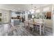 Bright dining area features wood-look floors, a chandelier, and a mirrored wall above the buffet at 4515 Sandstone Vista Ct, North Las Vegas, NV 89031