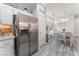Open layout view of stainless steel refrigerator and dining area featuring a buffet and white cabinetry at 4515 Sandstone Vista Ct, North Las Vegas, NV 89031