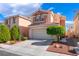 Two-story home with a well-manicured front yard, desert landscaping and attached two car garage at 4515 Sandstone Vista Ct, North Las Vegas, NV 89031