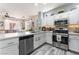 Open-concept kitchen featuring stainless steel appliances, light countertops, and white cabinetry at 4515 Sandstone Vista Ct, North Las Vegas, NV 89031