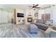 Open-concept living room with fireplace, stylish floors, and abundant natural light at 4515 Sandstone Vista Ct, North Las Vegas, NV 89031