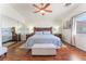 Spacious main bedroom features a wooden bed frame, ceiling fan and an abundance of natural light at 4515 Sandstone Vista Ct, North Las Vegas, NV 89031