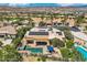 Aerial view of the property featuring the backyard swimming pool and patio, solar panels and views of the mountains beyond at 4980 Pensier St, Las Vegas, NV 89135