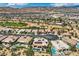 Neighborhood aerial with swimming pools, golf course and mountain views at 4980 Pensier St, Las Vegas, NV 89135