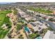 Aerial view of a neighborhood home with pool, solar panels and a golf course at 4980 Pensier St, Las Vegas, NV 89135