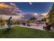 Spacious backyard with an outdoor kitchen, well-manicured lawn, and scenic views of the surrounding area at 4980 Pensier St, Las Vegas, NV 89135