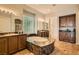 Elegant bathroom with a luxurious, large stone tub and dual vanities, plus a privacy block window at 4980 Pensier St, Las Vegas, NV 89135
