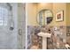 Charming bathroom with a glass enclosed shower, pedestal sink and unique tile backsplash at 4980 Pensier St, Las Vegas, NV 89135