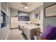 Cozy bedroom with two beds, soft carpet, and a ceiling fan; lots of light from the window at 4980 Pensier St, Las Vegas, NV 89135