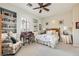 Cozy bedroom with hardwood floors, built-in shelving, and a comfortable armchair at 4980 Pensier St, Las Vegas, NV 89135