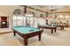 Spacious billiard room featuring multiple pool tables and elegant lighting fixtures at 4980 Pensier St, Las Vegas, NV 89135