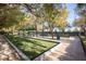 Bocce ball court surrounded by walking paths, benches, trees, and meticulous landscaping at 4980 Pensier St, Las Vegas, NV 89135