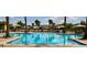Large community pool with plenty of seating and umbrellas, offering a refreshing escape for residents at 4980 Pensier St, Las Vegas, NV 89135