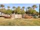 Community entrance sign surrounded by mature landscaping and palm trees at 4980 Pensier St, Las Vegas, NV 89135