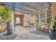 Relaxing courtyard area with shaded pergola, potted plants, decorative statues, and seating at 4980 Pensier St, Las Vegas, NV 89135