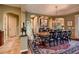 Elegant dining room featuring a long wooden table, traditional decor, and seamless access to the rest of the house at 4980 Pensier St, Las Vegas, NV 89135
