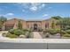 Charming one-story home with desert landscaping, a brick walkway, and an arched front entrance at 4980 Pensier St, Las Vegas, NV 89135