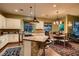 Beautiful kitchen with an island, modern appliances, wooden floor and a dining area with decor at 4980 Pensier St, Las Vegas, NV 89135