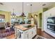 Open-concept kitchen with stainless appliances, granite island, breakfast nook, and seamless flow to the living area at 4980 Pensier St, Las Vegas, NV 89135