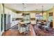 Bright, spacious kitchen with stainless steel appliances, a granite island with seating, and a cozy dining area at 4980 Pensier St, Las Vegas, NV 89135
