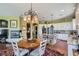 Open kitchen with island, stainless appliances, granite counters, a fireplace, and a dining area at 4980 Pensier St, Las Vegas, NV 89135