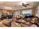 Spacious living room boasts an open floor plan, tray ceilings, hardwood floors, and views of the backyard and city at 4980 Pensier St, Las Vegas, NV 89135