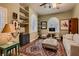 Cozy living room featuring a decorative rug, natural light from the windows, and built-in shelves at 4980 Pensier St, Las Vegas, NV 89135