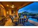 Outdoor patio with stylish seating, a ceiling fan, and views of the pool and surrounding landscape at 4980 Pensier St, Las Vegas, NV 89135
