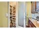 Well-stocked walk-in pantry offers generous storage with custom shelving and a frosted glass door at 4980 Pensier St, Las Vegas, NV 89135