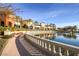 Scenic view of pond adjacent to building, with manicured walkway and lush landscaping at 4980 Pensier St, Las Vegas, NV 89135