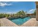 Secluded pool area with brick-lined pool, decorative plants, and privacy fence creating a relaxing oasis at 4980 Pensier St, Las Vegas, NV 89135